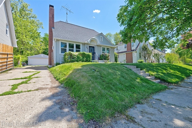 86 Marquette St, Pontiac, MI 48342 - view of front of house featuring a chimney, an outdoor structure, a front yard, a garage, and roof with shingles