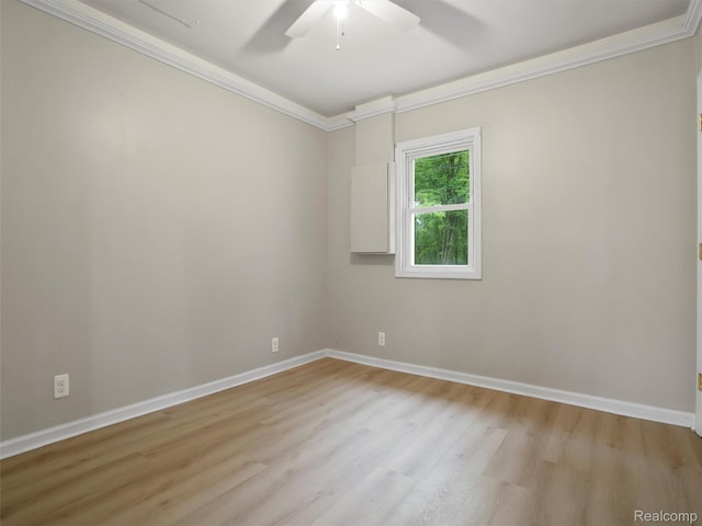 5220 County Line Rd, Lenox, MI 48048 - spare room featuring ornamental molding, ceiling fan, light wood-style flooring, and baseboards