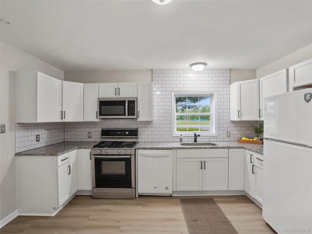 5220 County Line Rd, Lenox, MI 48048 - kitchen featuring stainless steel appliances, a sink, decorative backsplash, and white cabinetry