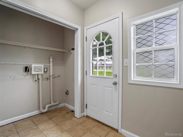 5220 County Line Rd, Lenox, MI 48048 - laundry room with baseboards and light tile patterned flooring
