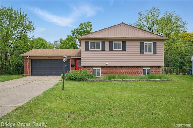 23850 Barfield St, Farmington, MI 48336 - tri-level home with a garage, driveway, a front yard, and brick siding