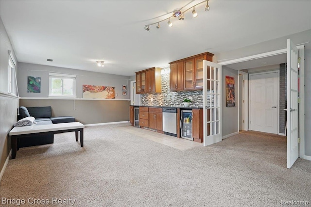 23850 Barfield St, Farmington, MI 48336 - kitchen featuring stainless steel dishwasher, brown cabinets, baseboards, and light carpet