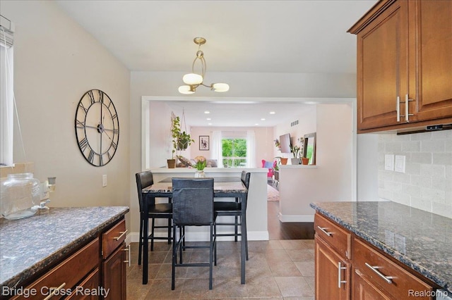 23850 Barfield St, Farmington, MI 48336 - dining area featuring a chandelier, baseboards, and light tile patterned floors