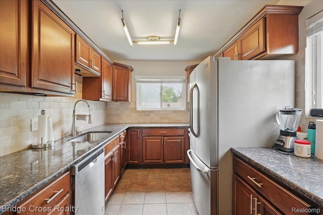 23850 Barfield St, Farmington, MI 48336 - kitchen featuring stainless steel dishwasher, a sink, freestanding refrigerator, and brown cabinetry