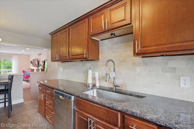 23850 Barfield St, Farmington, MI 48336 - kitchen with stainless steel dishwasher, a sink, backsplash, and brown cabinetry