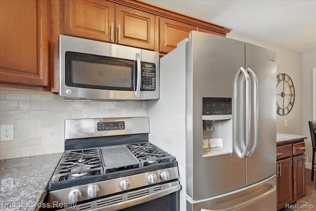23850 Barfield St, Farmington, MI 48336 - kitchen with stainless steel appliances, tasteful backsplash, and brown cabinets