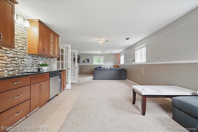 23850 Barfield St, Farmington, MI 48336 - kitchen with stainless steel dishwasher, a sink, open floor plan, and brown cabinets