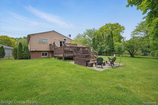23850 Barfield St, Farmington, MI 48336 - rear view of property with a wooden deck and a fire pit