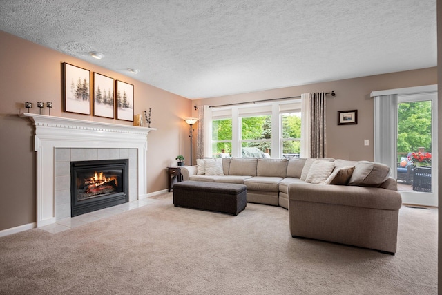 4388 Lori Lynn Ln, Whitmore Lake, MI 48189 - carpeted living area featuring a tiled fireplace, plenty of natural light, a textured ceiling, and baseboards