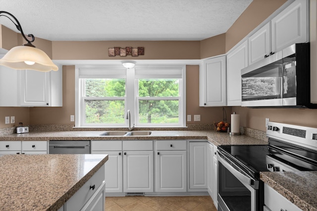 4388 Lori Lynn Ln, Whitmore Lake, MI 48189 - kitchen featuring stainless steel appliances, a sink, white cabinetry, pendant lighting, and a textured ceiling