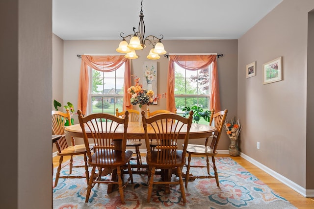 4388 Lori Lynn Ln, Whitmore Lake, MI 48189 - dining area with plenty of natural light, a chandelier, wood finished floors, and baseboards