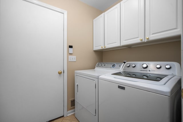 4388 Lori Lynn Ln, Whitmore Lake, MI 48189 - washroom featuring washing machine and clothes dryer, cabinet space, light tile patterned flooring, and baseboards