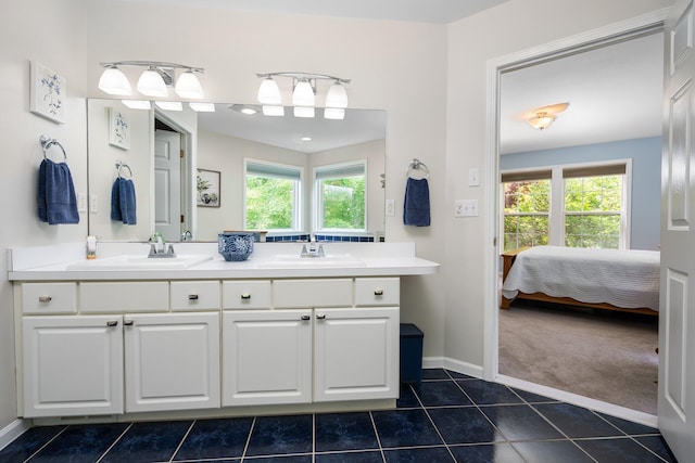 4388 Lori Lynn Ln, Whitmore Lake, MI 48189 - ensuite bathroom featuring double vanity, tile patterned flooring, and baseboards