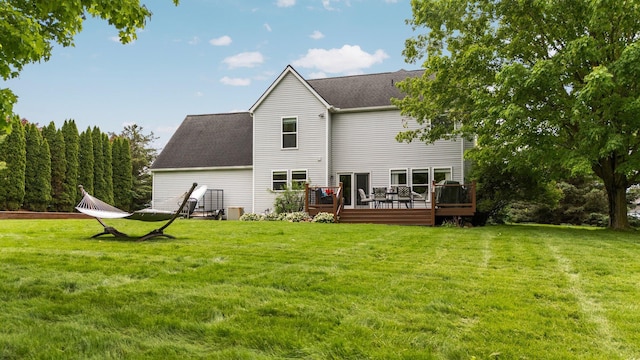 4388 Lori Lynn Ln, Whitmore Lake, MI 48189 - back of house featuring roof with shingles, a wooden deck, and a lawn