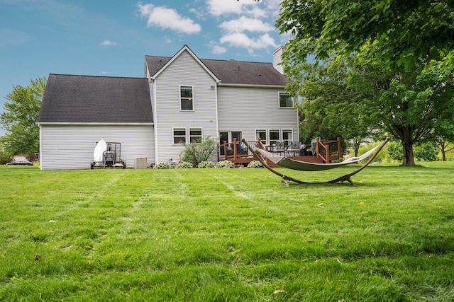 4388 Lori Lynn Ln, Whitmore Lake, MI 48189 - back of house with a chimney, a deck, and a lawn