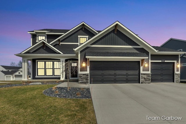 1757 Julienne Ct, Byron Center, MI 49315 - craftsman house with a garage, concrete driveway, a front lawn, board and batten siding, and stone siding