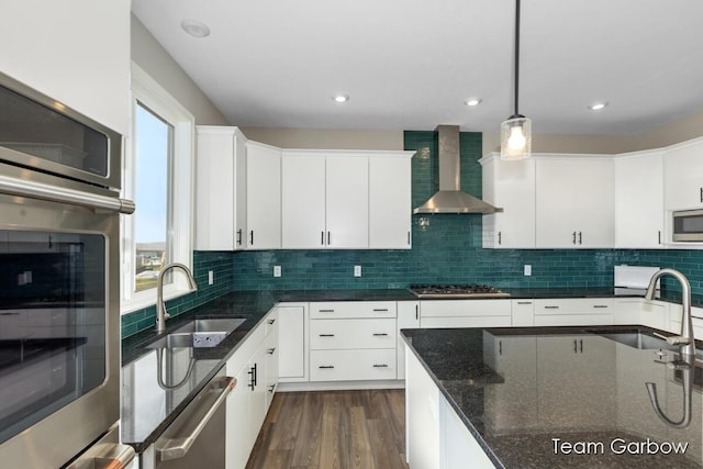 1757 Julienne Ct, Byron Center, MI 49315 - kitchen featuring wall chimney exhaust hood, a sink, appliances with stainless steel finishes, decorative light fixtures, and recessed lighting