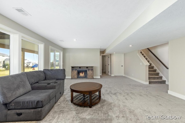 1757 Julienne Ct, Byron Center, MI 49315 - carpeted living area with baseboards, a stone fireplace, stairway, and recessed lighting