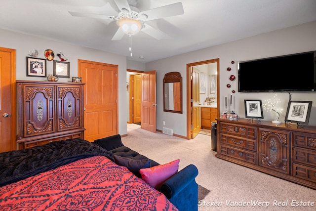 2567 Chippewa Trl, Muskegon, MI 49445 - bedroom with carpet flooring, baseboards, ensuite bathroom, and a ceiling fan