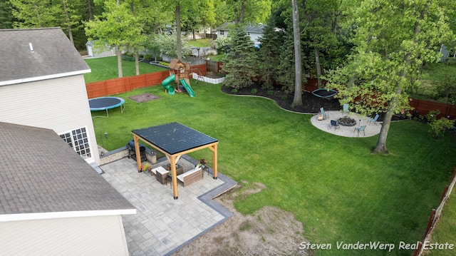 2567 Chippewa Trl, Muskegon, MI 49445 - view of yard with a playground, a trampoline, a patio, a fire pit, and a gazebo
