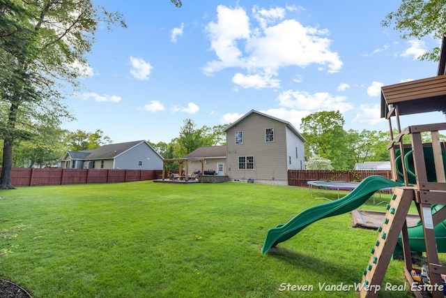 2567 Chippewa Trl, Muskegon, MI 49445 - view of yard with a trampoline and a playground