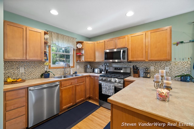 2567 Chippewa Trl, Muskegon, MI 49445 - kitchen featuring stainless steel appliances, a sink, open shelves, light countertops, and recessed lighting