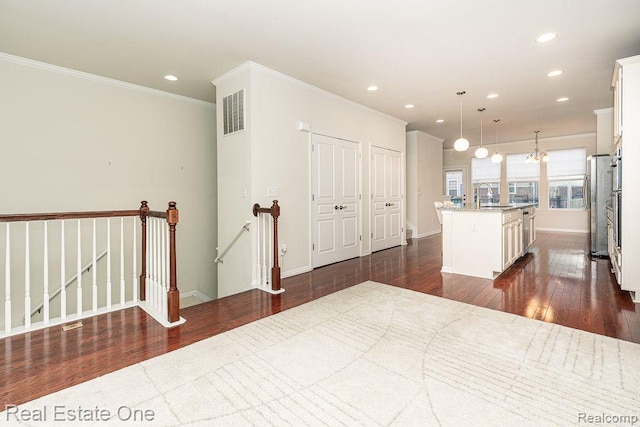 2669 Helmsdale Cir, Rochester, MI 48307 - kitchen featuring dark wood-type flooring, recessed lighting, ornamental molding, appliances with stainless steel finishes, and white cabinetry