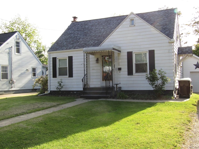 736 State St, Adrian, MI 49221 - bungalow with a front yard, roof with shingles, and a garage