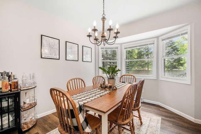 3025 Juneberry Ave SE, Grand Rapids, MI 49508 - dining room featuring a chandelier, baseboards, and dark wood-type flooring