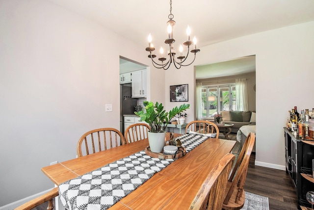3025 Juneberry Ave SE, Grand Rapids, MI 49508 - dining room with a chandelier, dark wood finished floors, and baseboards