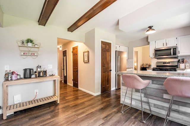 3025 Juneberry Ave SE, Grand Rapids, MI 49508 - kitchen with stainless steel appliances, a kitchen bar, white cabinets, backsplash, and beam ceiling