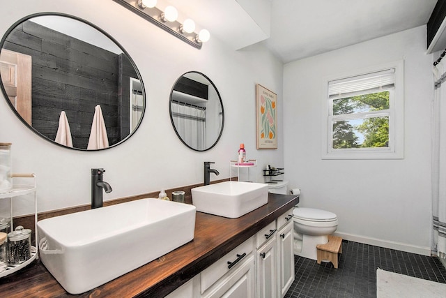 3025 Juneberry Ave SE, Grand Rapids, MI 49508 - bathroom with double vanity, toilet, tile patterned flooring, and baseboards