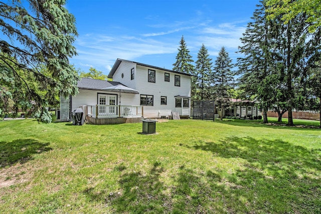 3025 Juneberry Ave SE, Grand Rapids, MI 49508 - rear view of property featuring a wooden deck, a yard, and french doors