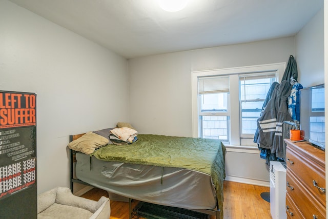 733 Lafayette Ave NE, Grand Rapids, MI 49503 - bedroom with wood finished floors, multiple windows, and baseboards