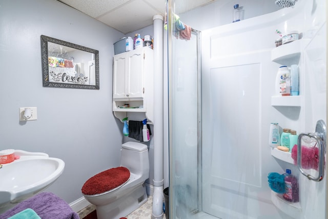 733 Lafayette Ave NE, Grand Rapids, MI 49503 - bathroom with a stall shower, a sink, baseboards, toilet, and a paneled ceiling