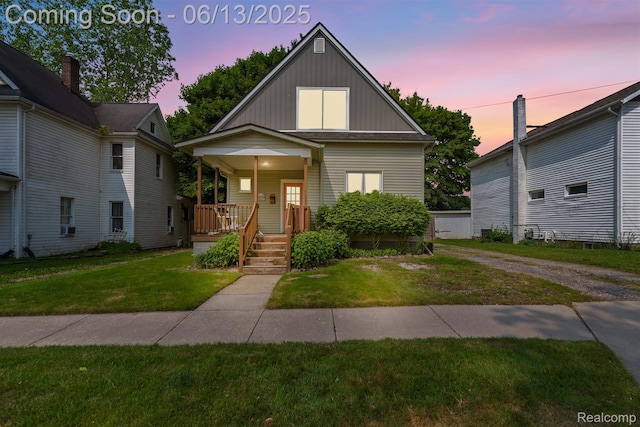 1 Jones St, Yale, MI 48097 - view of front facade with board and batten siding, covered porch, and a lawn