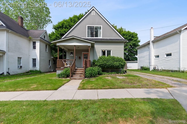 1 Jones St, Yale, MI 48097 - view of front of property with board and batten siding, a front yard, and a porch