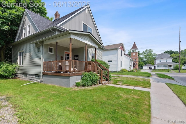 1 Jones St, Yale, MI 48097 - view of front of home with covered porch, a front lawn, a chimney, and a shingled roof