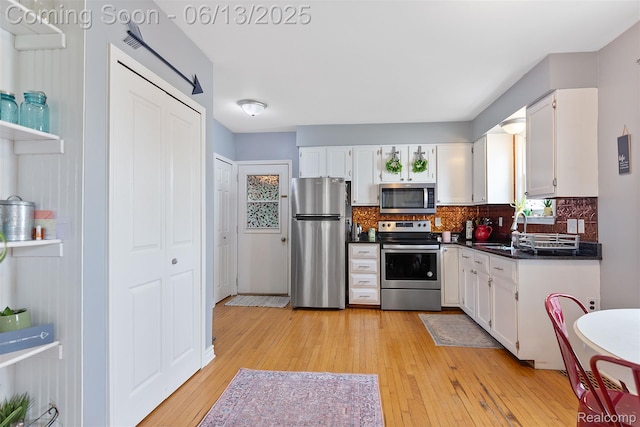 1 Jones St, Yale, MI 48097 - kitchen with appliances with stainless steel finishes, dark countertops, white cabinetry, and backsplash
