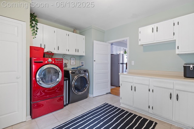 1 Jones St, Yale, MI 48097 - laundry area featuring washing machine and dryer, cabinet space, and light tile patterned floors