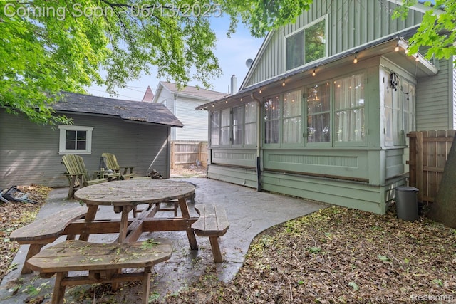 1 Jones St, Yale, MI 48097 - back of property featuring a patio, a sunroom, and board and batten siding