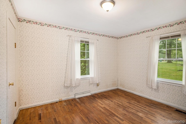 613 Genesee Ave, Gaines, MI 48436 - unfurnished room with wood finished floors, baseboards, and wallpapered walls