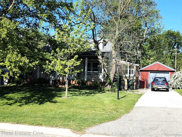 3255 Willet Ave, Rochester Hills, MI 48309 - view of property hidden behind natural elements featuring driveway, a detached garage, a front yard, and an outdoor structure