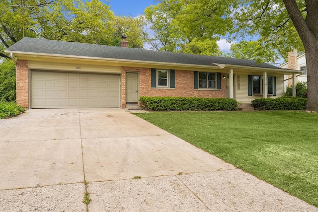 5042 Brookgate Dr NW, Comstock Park, MI 49321 - ranch-style home featuring brick siding, a chimney, concrete driveway, a front yard, and an attached garage