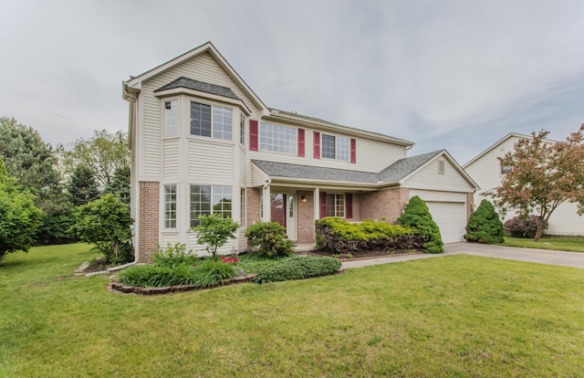 324 Redrock Ct, Ann Arbor, MI 48103 - traditional-style home with driveway, a garage, brick siding, and a front yard