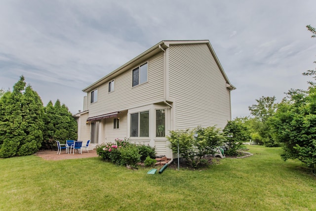 324 Redrock Ct, Ann Arbor, MI 48103 - rear view of house with a patio and a yard