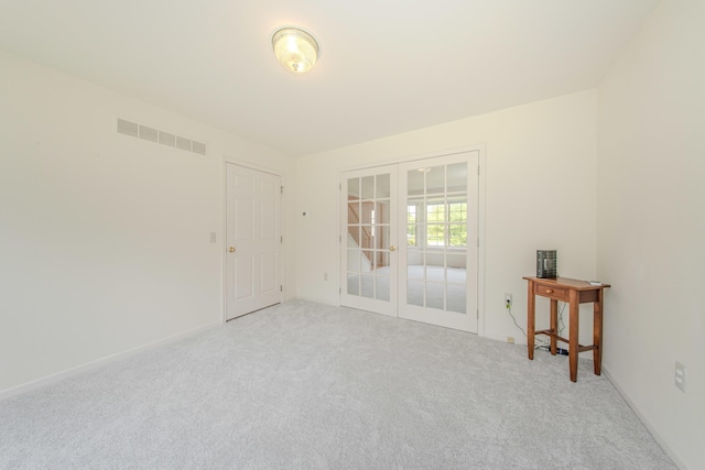 324 Redrock Ct, Ann Arbor, MI 48103 - spare room featuring french doors, light carpet, and baseboards