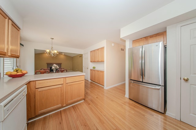 324 Redrock Ct, Ann Arbor, MI 48103 - kitchen with freestanding refrigerator, white dishwasher, a peninsula, light wood finished floors, and a chandelier