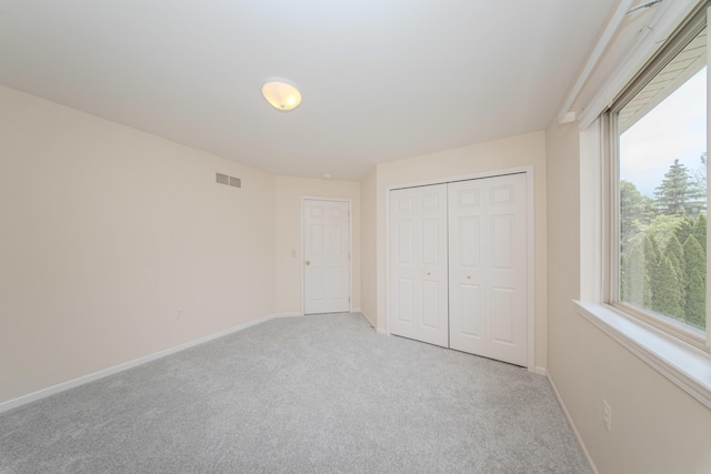 324 Redrock Ct, Ann Arbor, MI 48103 - unfurnished bedroom with light carpet, baseboards, and a closet