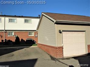 20938 Hunt Dr Unit 52, Roseville, MI 48066 - view of side of property with brick siding and a garage